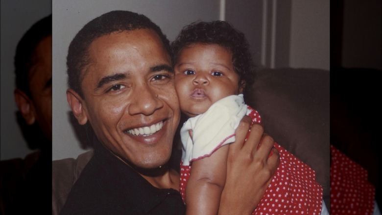 Obama holding his daughter Sasha