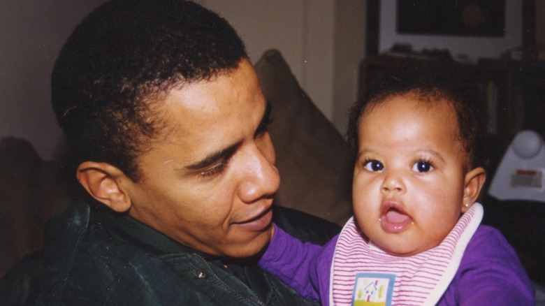 Obama holding his daughter Malia