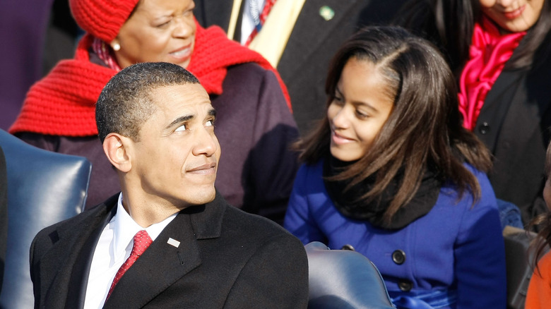 Malia and Barack Obama look at each other affectionately