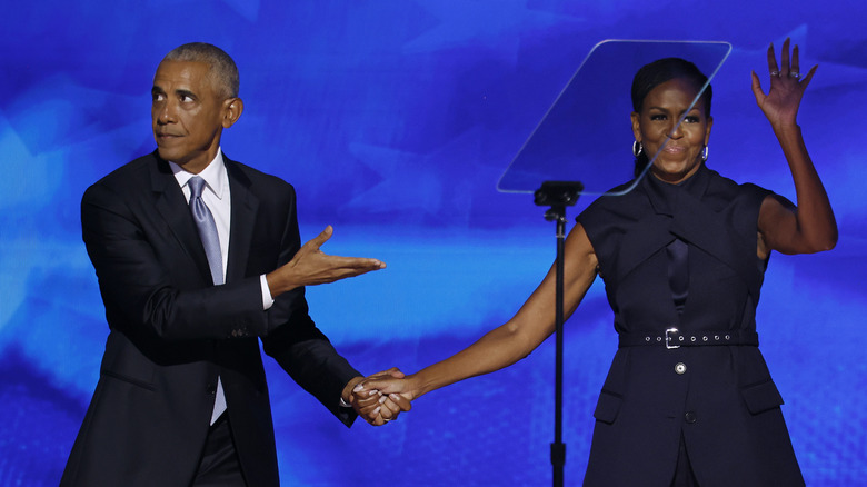 Michelle and Barack Obama holding hands