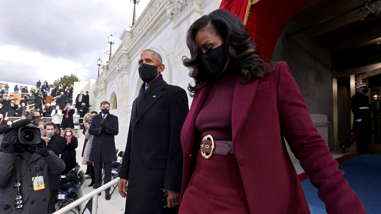 Michelle and Barack Obama holding hands