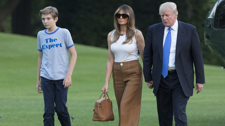 Barron Trump walking with his parents