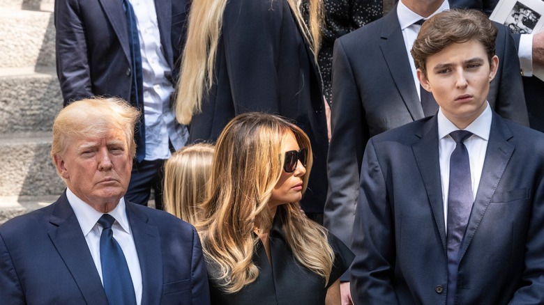 Barron Trump standing with his parents