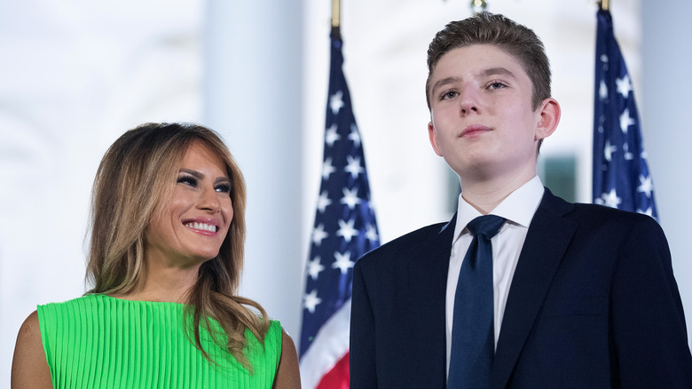 Barron Trump standing beside Melania Trump 