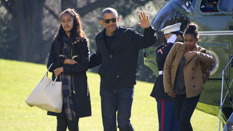 Barack Obama waving with Malia and Sasha