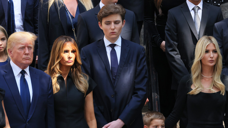 Barron Trump standing tall over his mother Melania and his father Donald Trump