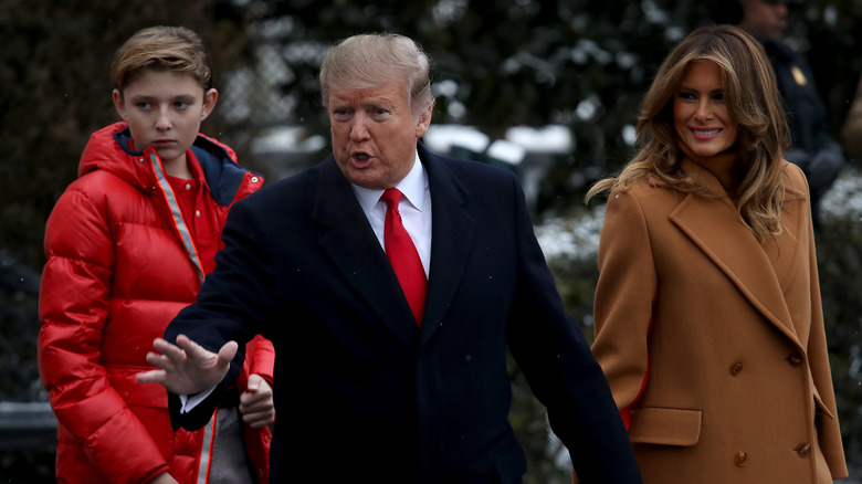 Barron, Donald, and Melania Trump wearing coats