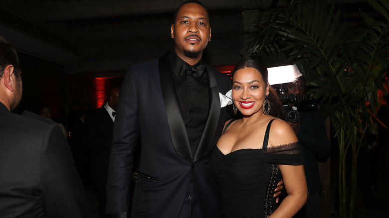 Carmelo Anthony and La La Anthony, both dressed in black outfits