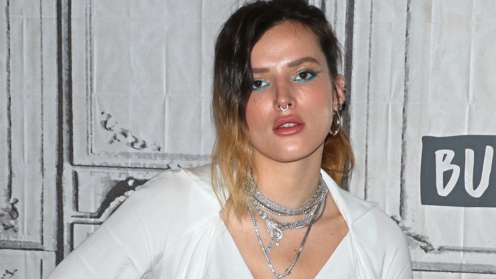 Bella Thorne with blue eyeshadow and silver necklaces