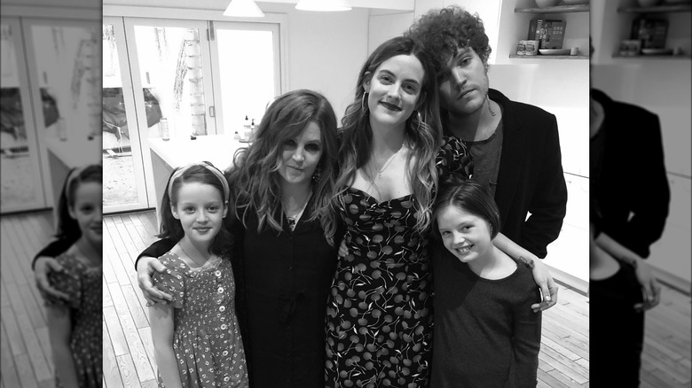 Lisa Marie Presley standing and posing with her four kids