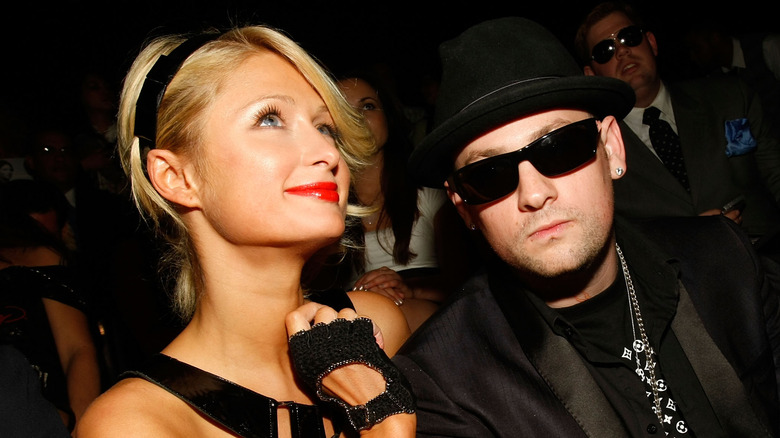 Paris Hilton gazes up as Benji Madden looks into the camera 