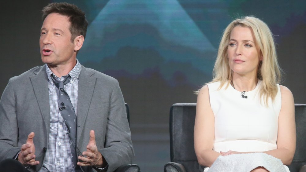 David Duchovny and Gillian Anderson sitting far apart at a panel interview