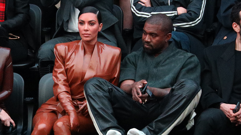 Kim Kardashian with Kanye West at a fashion show