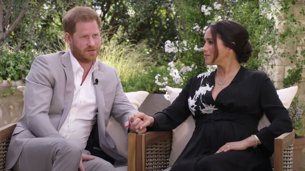 Prince Harry and Meghan Markle holding hands