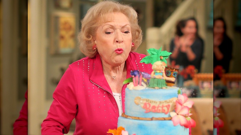 Betty White blowing out the candles on her 93rd birthday cake.