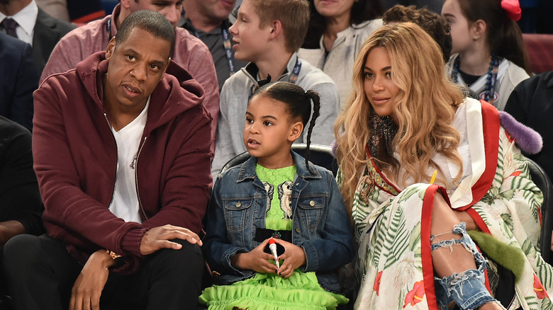 Jay-Z, Blue Ivy, and Beyoncé watching a game