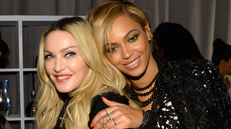 Beyoncé hugging Madonna from behind