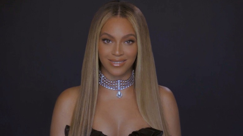 Beyoncé wears a black dress and a diamond choker necklace