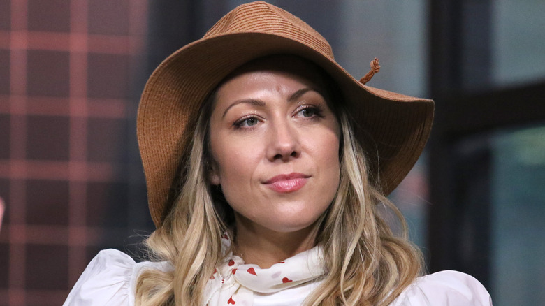 Colbie Caillat sitting for an interview in a hat