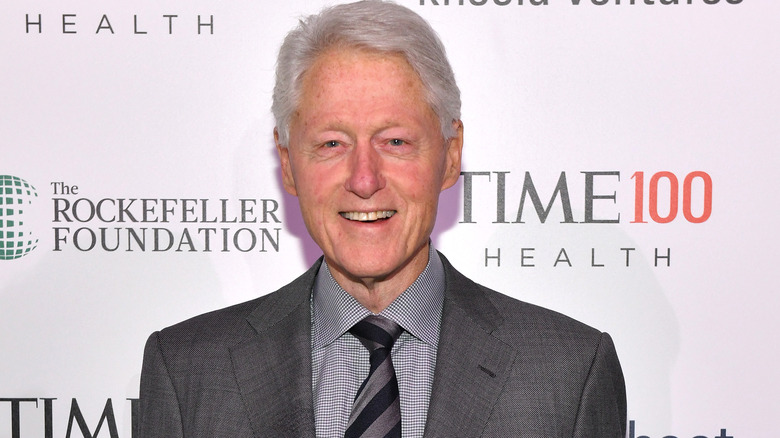 Bill Clinton smiles on the red carpet