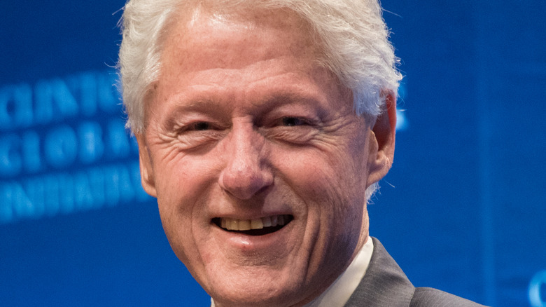 Bill Clinton smiles at a speaking engagement