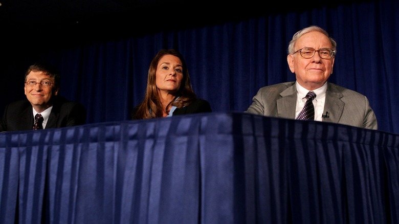 Bill Gates, Melinda Gates, and Warren Buffett at a conference