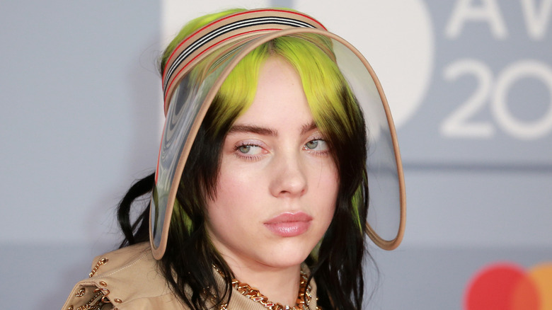 Billie Eilish poses in an usual hat