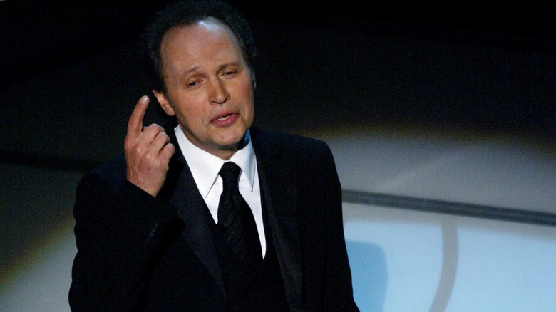 Billy Crystal speaking on stage at the 2004 Academy Awards