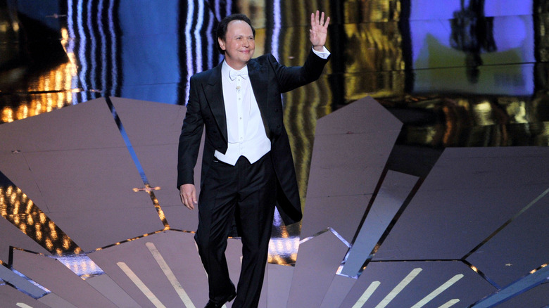 Billy Crystal performing onstage during the 84th Annual Academy Awards