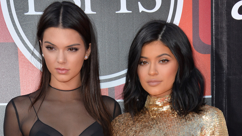 Kendall and Kylie Jenner posing at an event