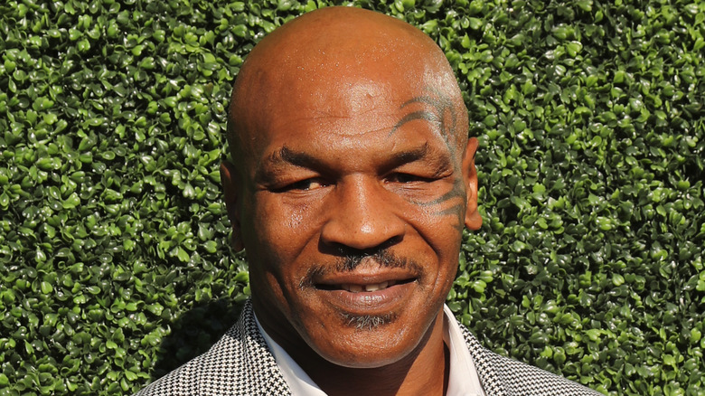 Mike Tyson at an event, smiling