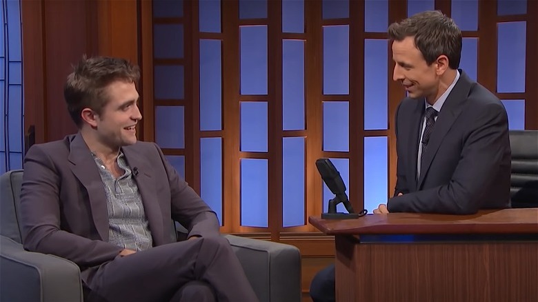 Robert Pattinson and Seth Meyers looking at one another