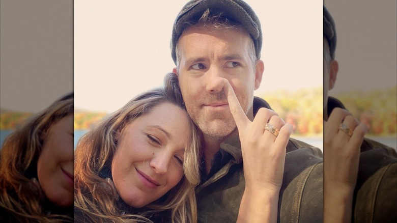 Blake Lively sticking her finger in Ryan Reynolds' nose