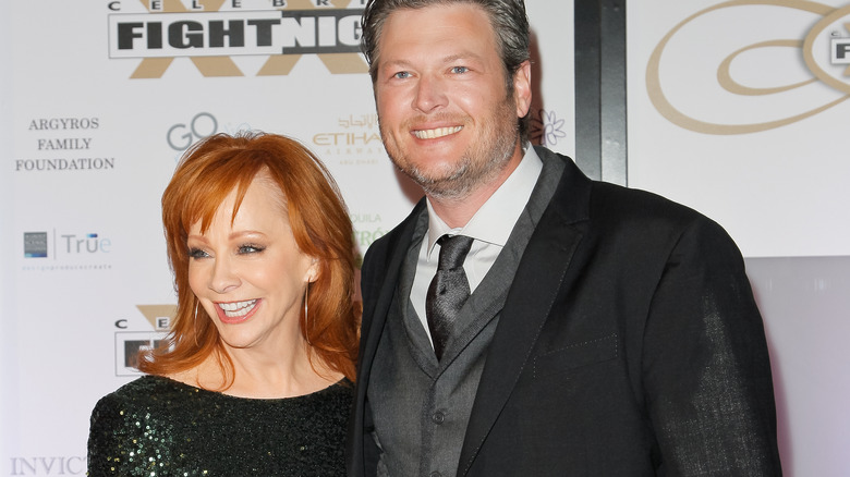 Reba McEntire and Blake Shelton posing