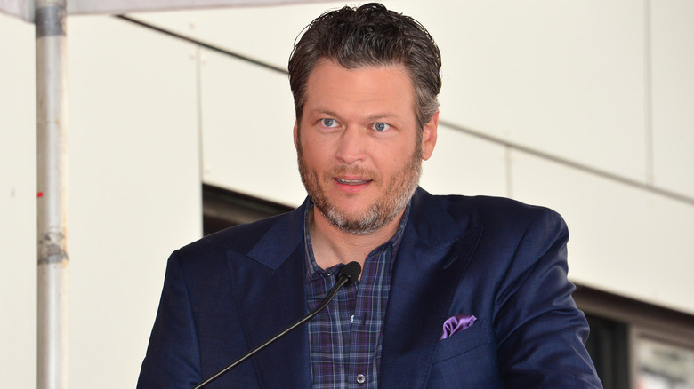 Blake Shelton speaking at microphone