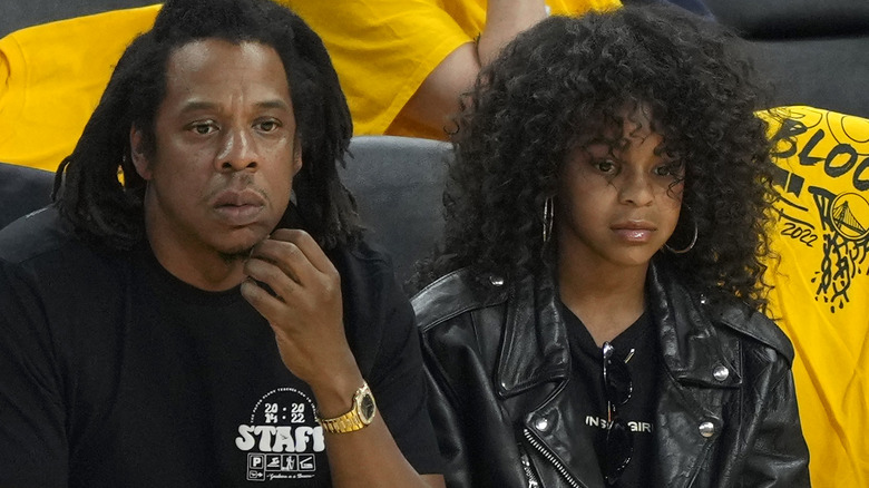 Rapper Jay-Z and his daughter Blue Ivy Carter look on during the second quarter of Game Five of the 2022 NBA Finals 