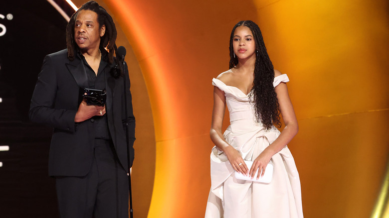 Jay Z and Blue Ivy standing on stage