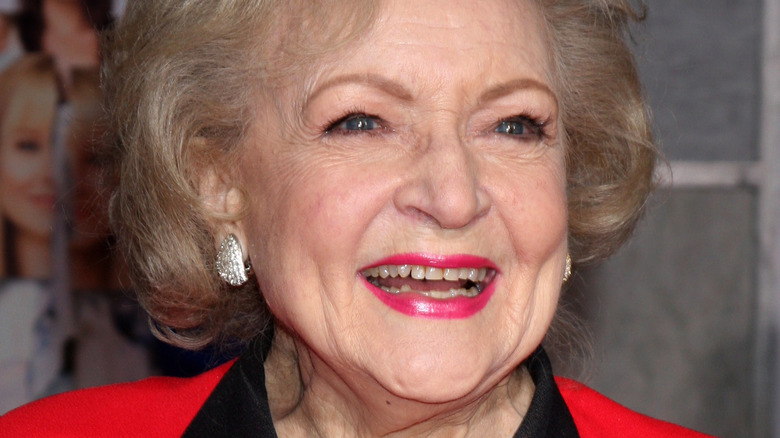 Betty White smiling in red