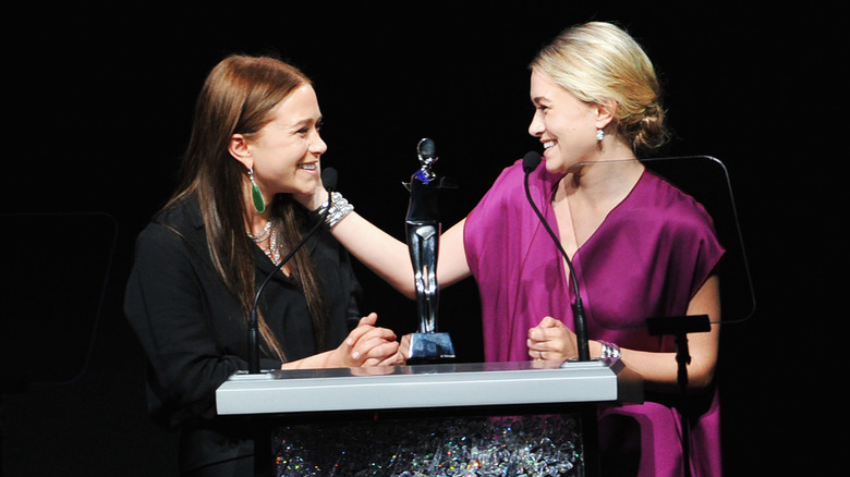 Mary-Kate and Ashley Olsen accept an award together