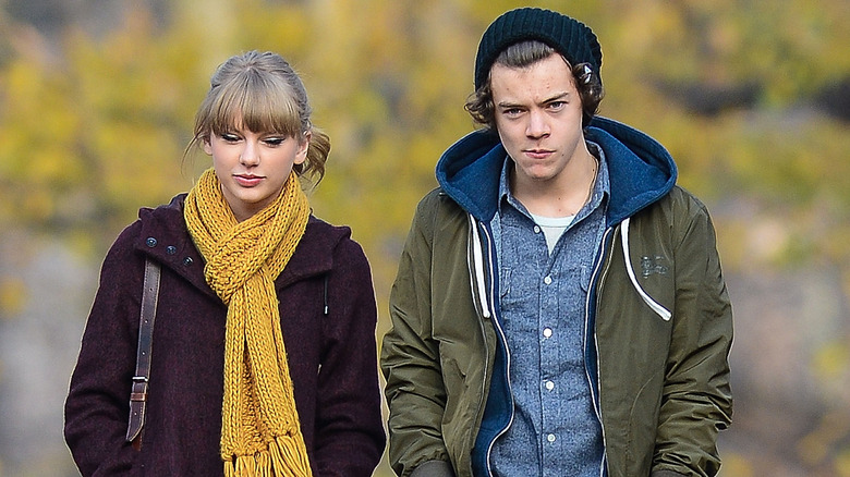 Taylor Swift and Harry Styles walking outdoors