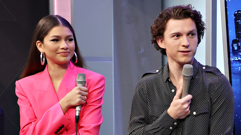 Zendaya sitting next to Tom Holland