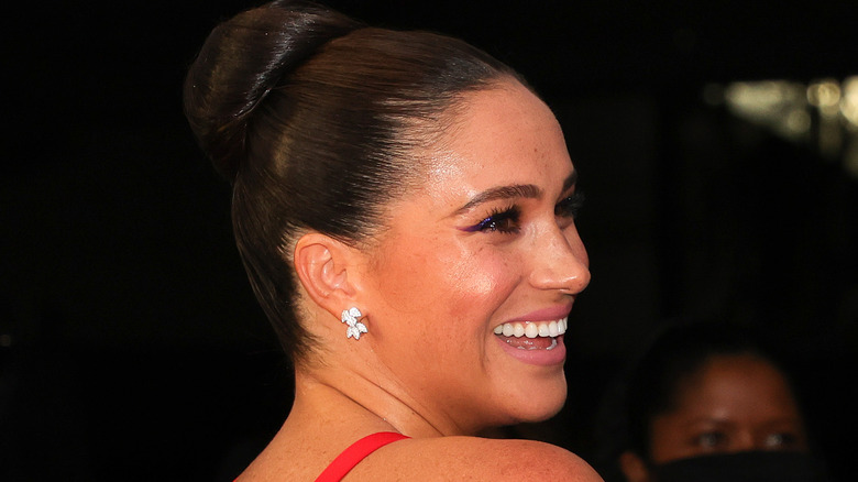 Meghan Markle smiling over her shoulder