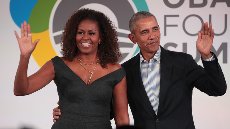 Michelle and Barack Obama waving