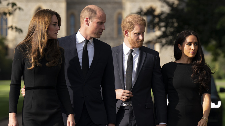 Kate Middleton, Prince William, Prince Harry, and Meghan Markle walk outside of Windsor Castle