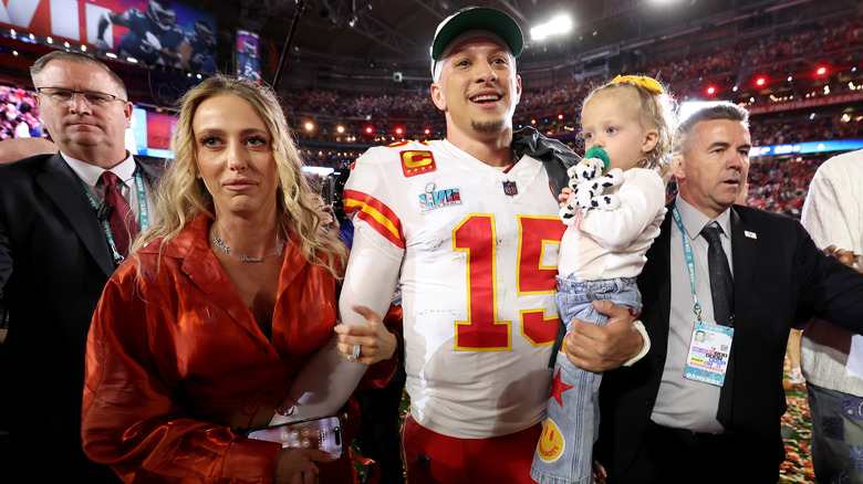 Brittany Mahomes gripping Patrick Mahomes' arm