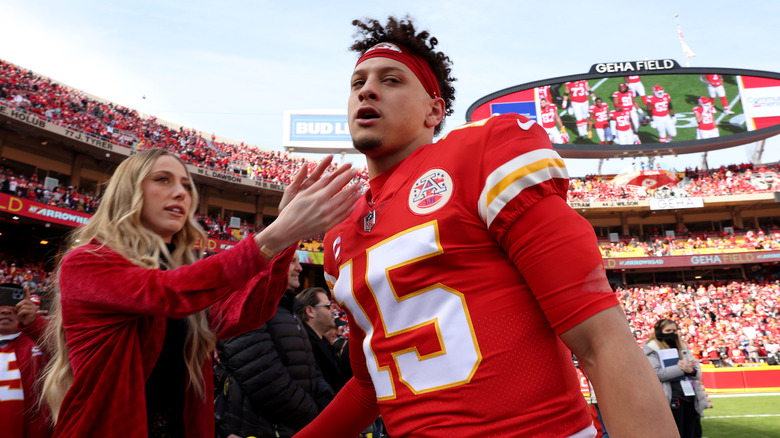 Brittany Mahomes reaching for Patrick Mahomes