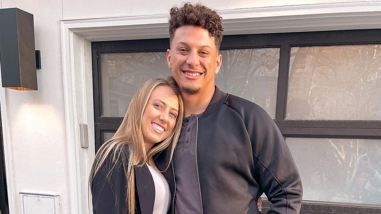 Brittany Mahomes resting head on Patrick Mahomes