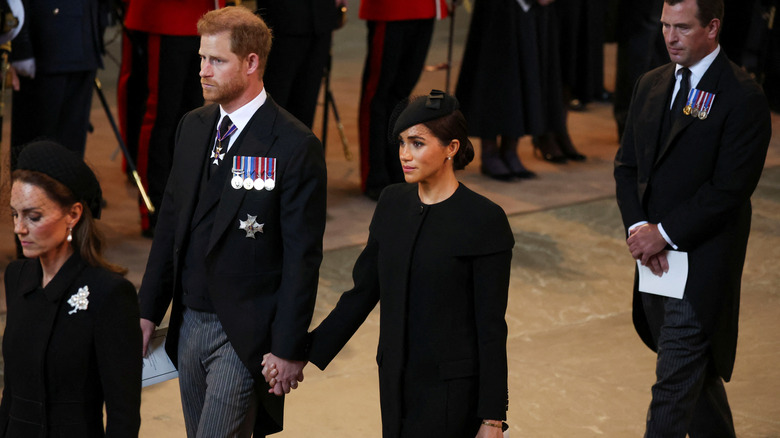 Prince Harry, Meghan Markle holding hands