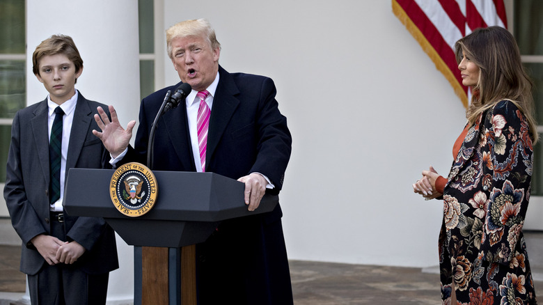 Donald Trump speaking beside Barron and Melania Trump