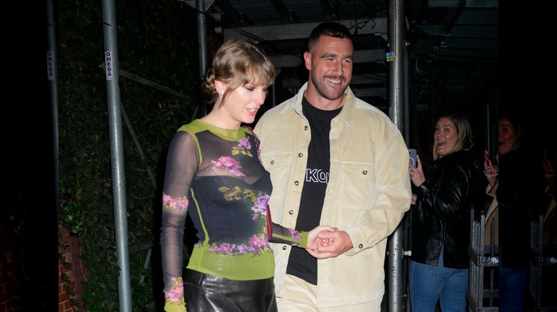 Taylor Swift and Travis Kelce holding hands